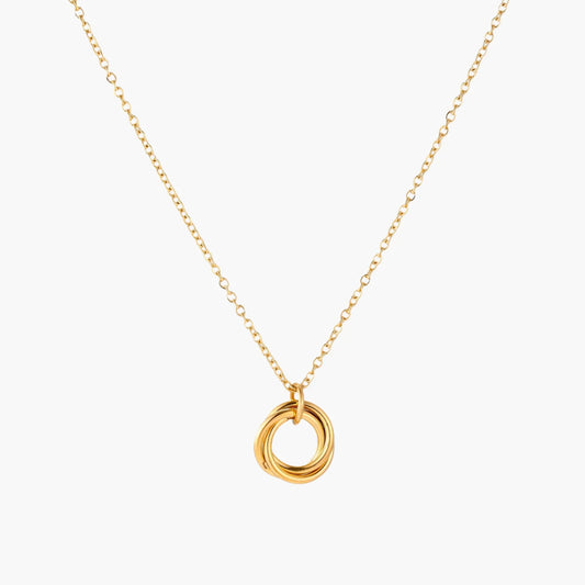 Delicate gold-plated necklace with three interlocking circle rings forming a minimalist knot pendant on cream background