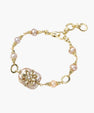 Gold-plated bracelet with pink baroque pearl centerpiece, floral connector, and freshwater pearls