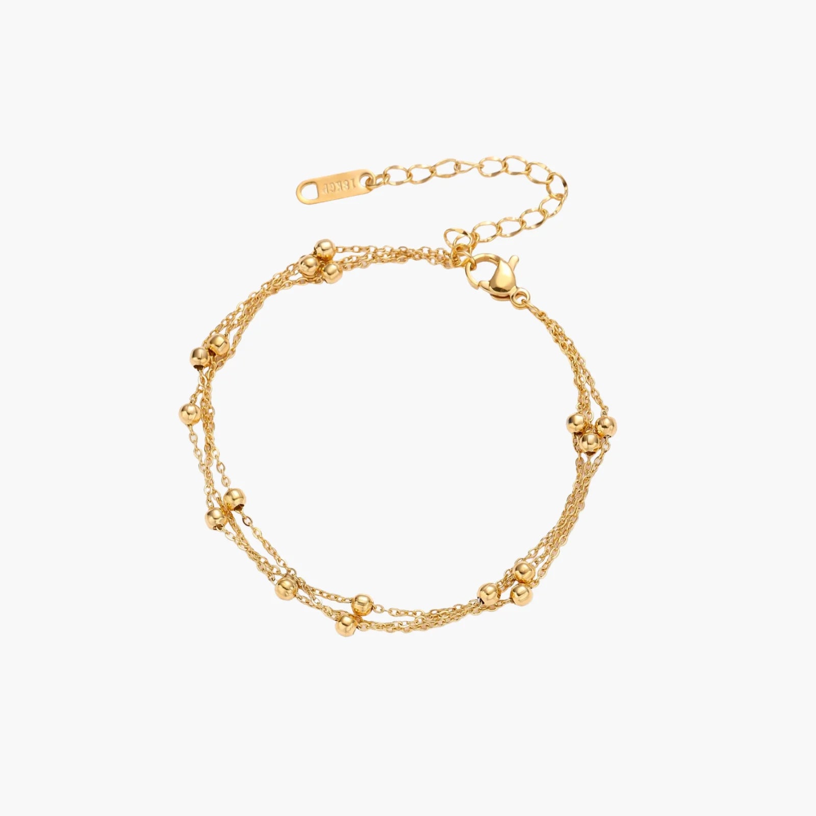 Three-strand gold-plated bracelet with clustered ball beads and adjustable clasp on cream background
