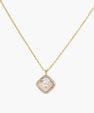 Gold quatrefoil pendant with crystal center on iridescent mother-of-pearl base, adjustable gold chain on cream background