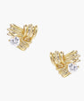 Pair of sculptural gold-plated wing stud earrings with zirconia stones on cream background, showing dimensional feather design
