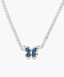 White gold plated tennis necklace with blue denim butterfly pendant and clear zirconia stones on cream background