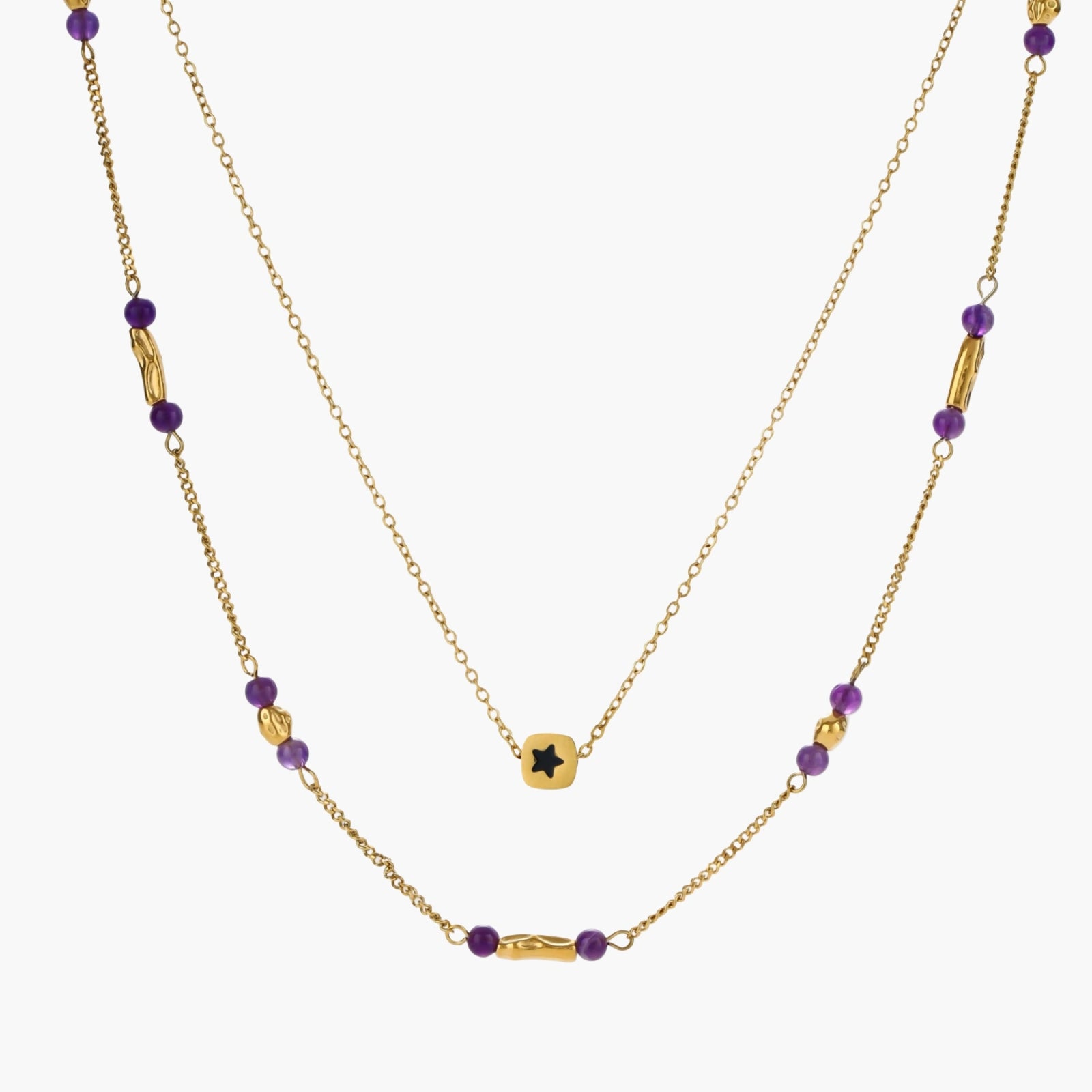 Two layered gold-tone necklaces with purple stone beads and star pendant against cream background.